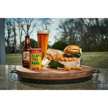 Tray with a burger, fries, and drinks on a grassy outdoor background